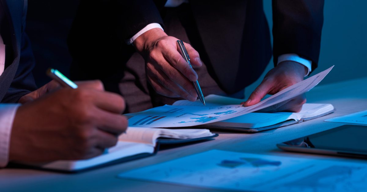 Close-up image of business partners working with financial documents